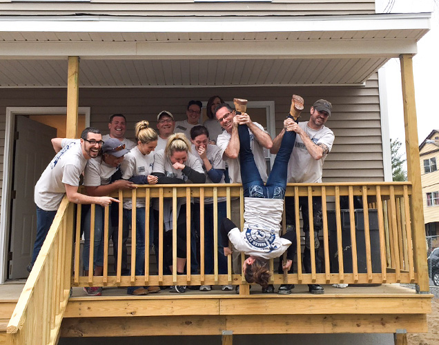Employees help build a house with Habitat for Humanity